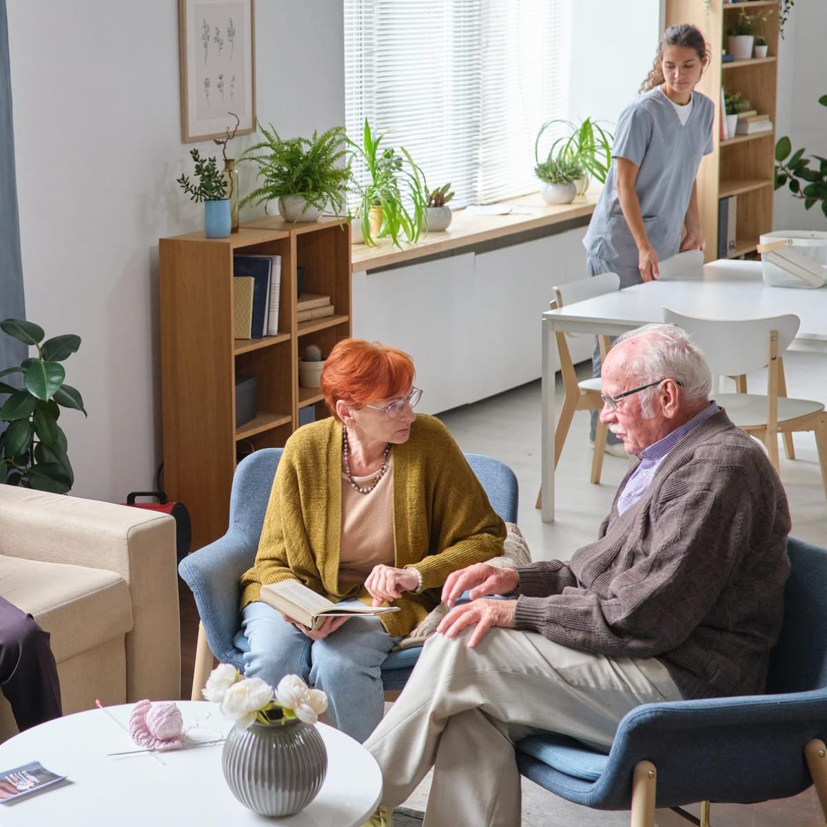 Elderly couple sitting in some chairs next to each other